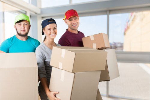 Local removals team handling boxes and furniture in East London