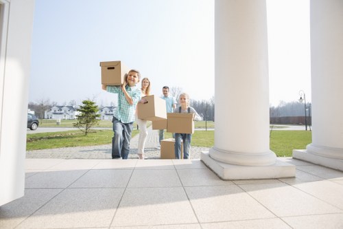 Professional movers carrying household furniture in Bethnalgreen