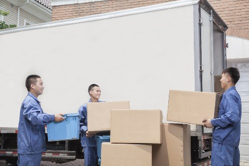 Removal team loading boxes in Bethnal Green street