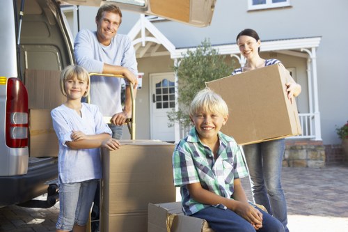 Trained removal staff handling boxes and furniture with care