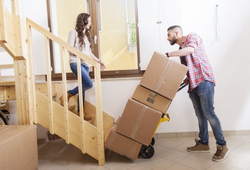 Moving team handling furniture in a Bethnal Green flat