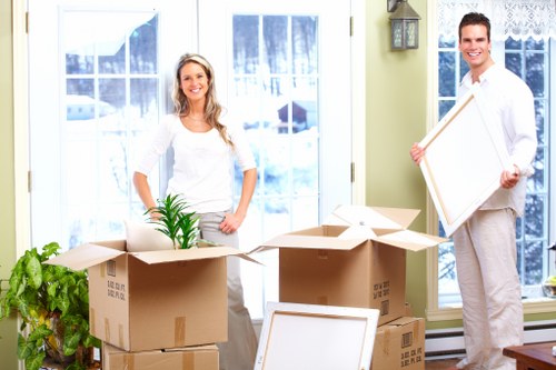 Professional furniture collection team handling sofas and tables in Bethnalgreen
